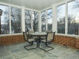 Screened in masonry porch with flagstone floor