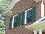 Functional shutters, historically accurate brick jack arches, rich cornice and column details