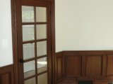 Custom cherry wainscot, cherry door and transom