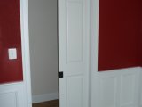 Pocket door and paneled wainscot