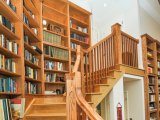 Oak built ins with mahogany inlays wrap around stair from basement to second level, mahogany inlays match mahogany ballusters at stair rail